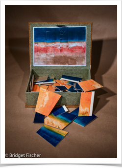 Box with Monotype cut into a puzzle
